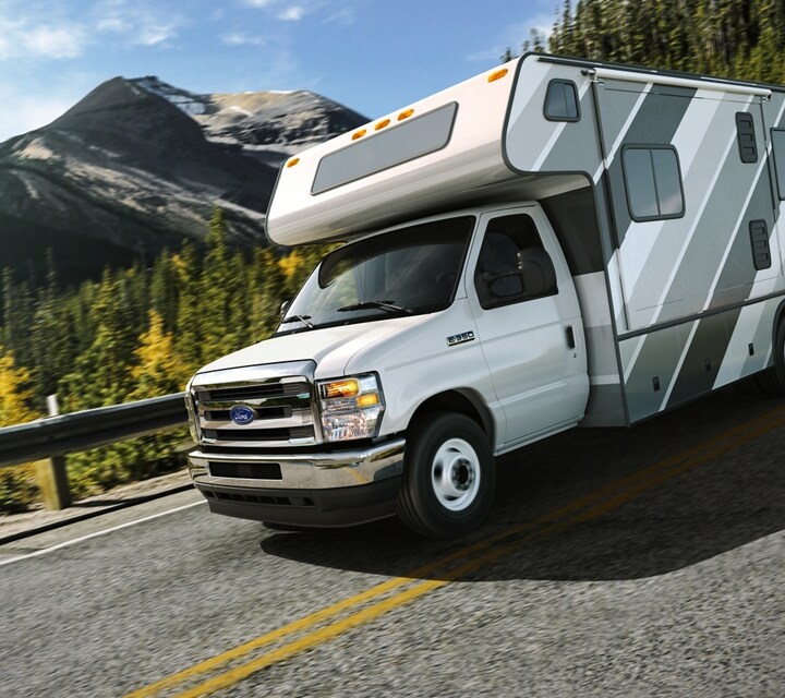 2026 Ford E-Series Cutaway dual-rear-wheel with Class C motorhome package being driven on a bridge