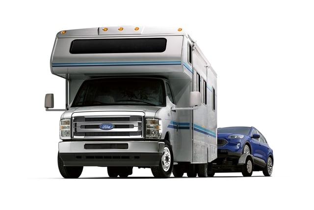2026 Ford E-Series Cutaway with Class C motorhome towing a car on a trailer