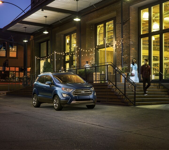 2021 Ford EcoSport Titanium in Lightning Blue parked on city street near large buildings
