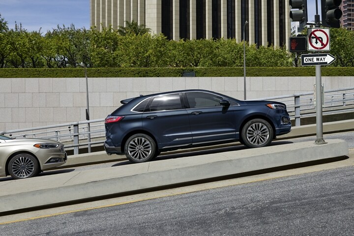 2023 Ford Edge® Titanium Elite SUV in Stone Blue stopped on a steep hill