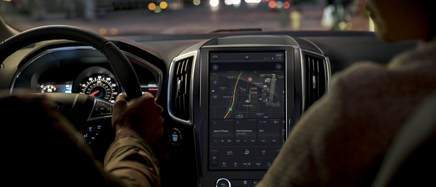 Interior of 2023 Ford Edge® ST-Line at night being driven down city street