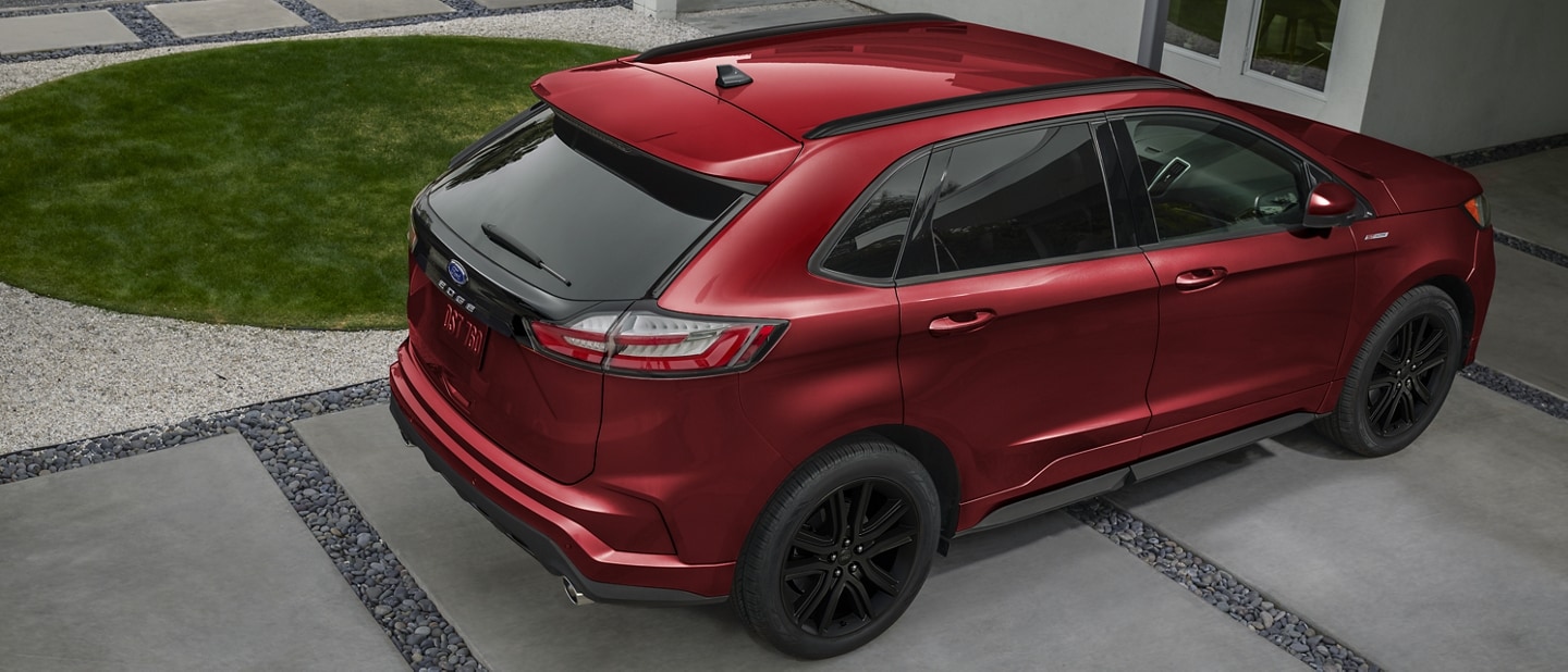 A 2023 Ford Edge® ST in Rapid Red parked in a driveway