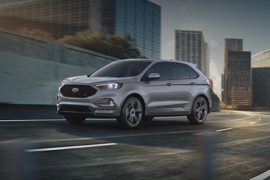 2023 Ford Edge® SUV in Iconic Silver being driven through a city