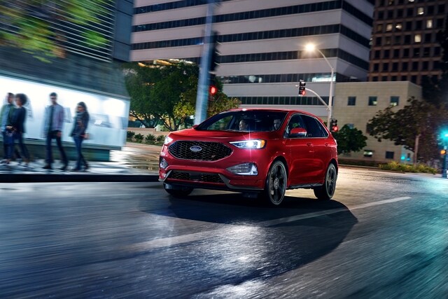 2023 Ford Edge® in Rapid Red being driven down a city street