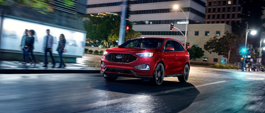 2024 Ford Edge® in Rapid Red being driven down a city street