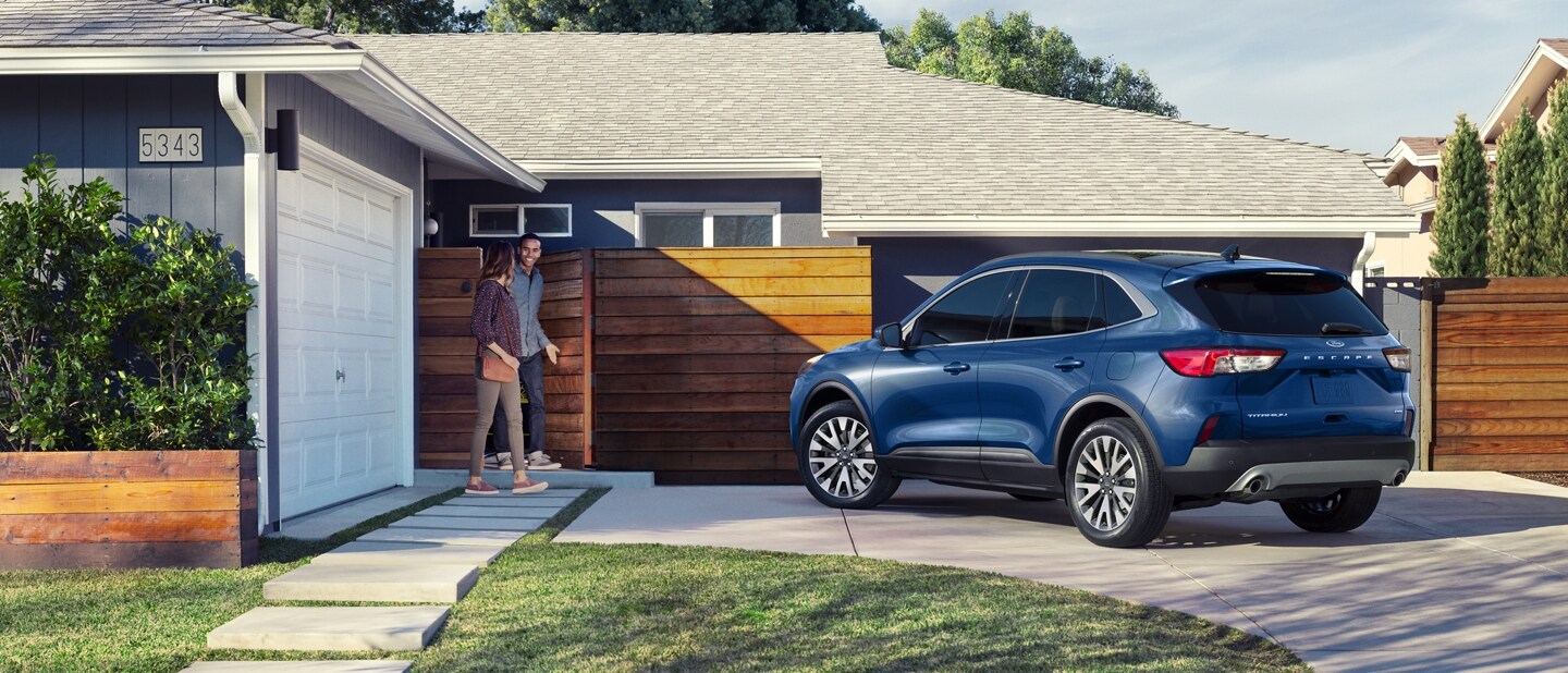2022 Ford Escape Titanium in Atlas Blue Metallic parked in a residential driveway