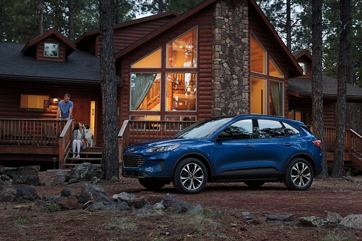 2022 Ford Escape SE with SE Appearance Package in Atlas Blue Metallic parked outside a cabin