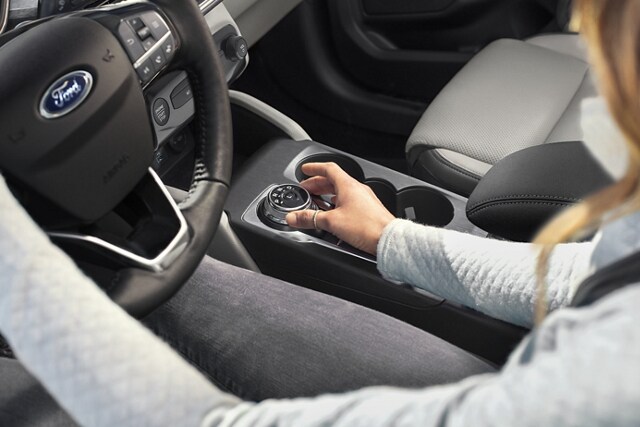 Interior view of 2023 Ford Escape® with driver using the standard rotary gear shift dial