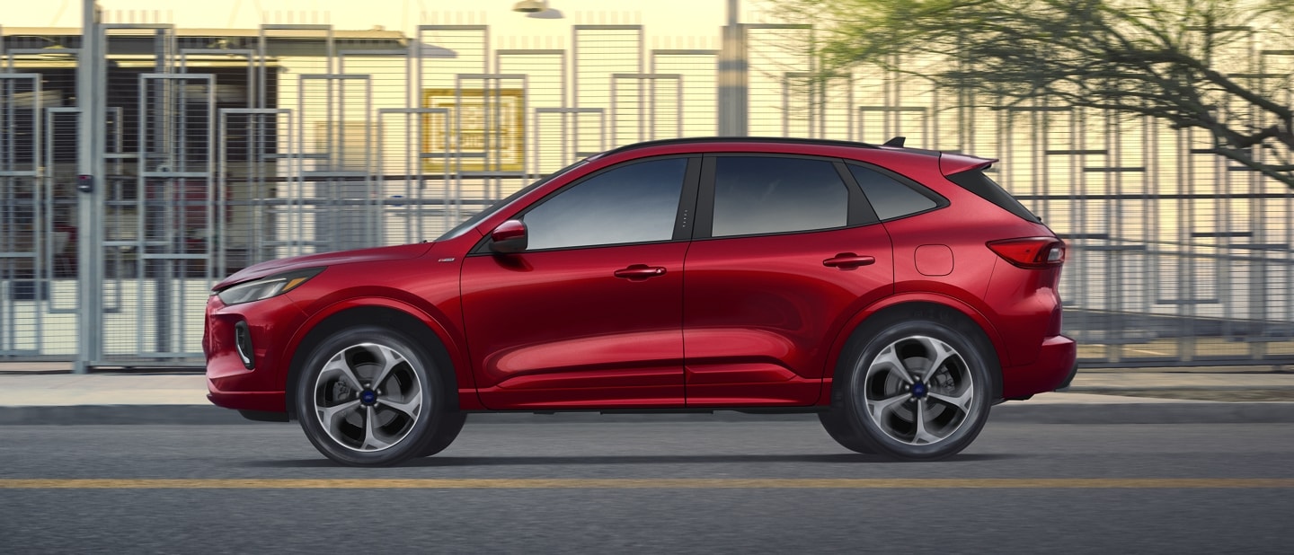 2023 Ford Escape® in Rapid Red Metallic being driven down a road