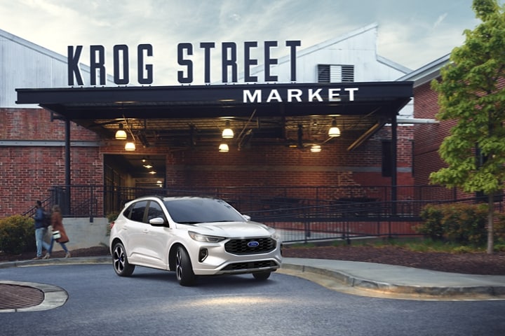 2023 Ford Escape® in Star White parked next to a sidewalk
