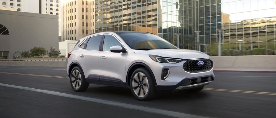 2023 Ford Escape® in Star White being driven down a city road