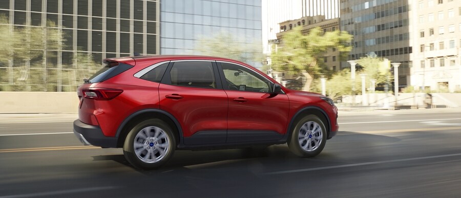 2023 Ford Escape® in Rapid Red Metallic being driven down a city road