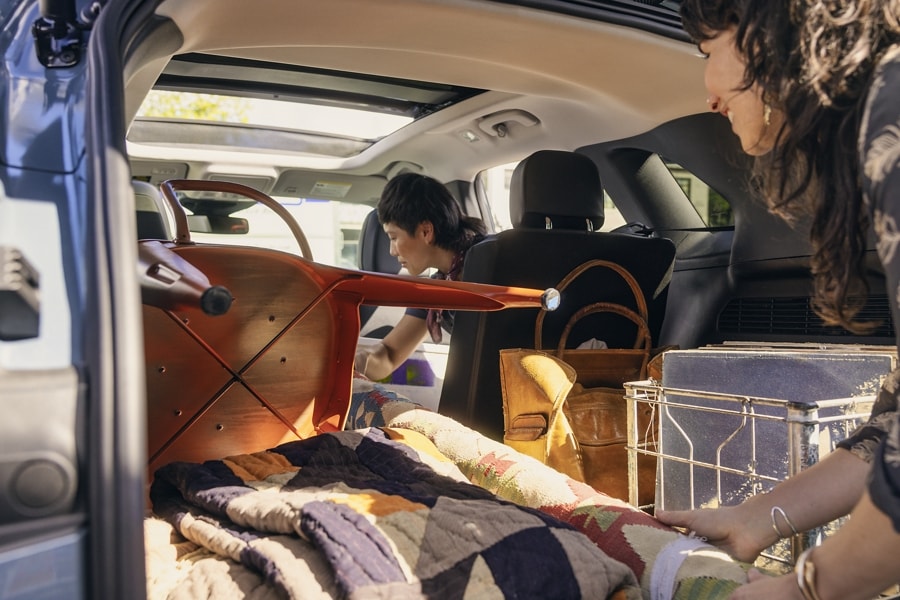 A 2023 Ford Escape® with rear hatch open as people load stuff into it