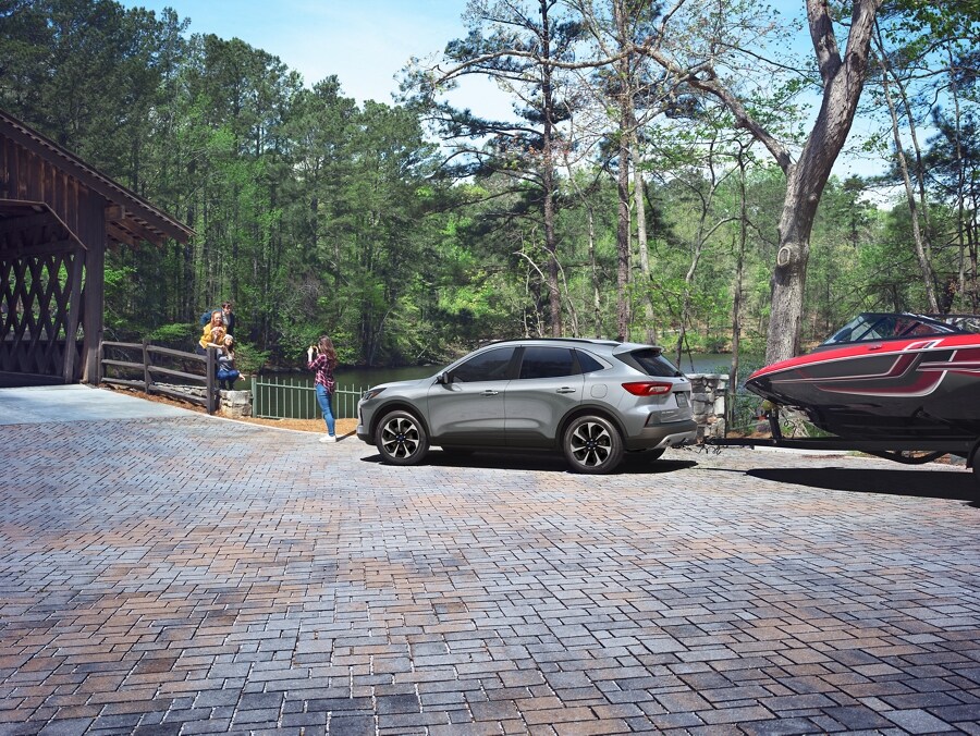 Profile view of a 2024 Ford Escape® The bow of a boat hitched to the Escape is visible