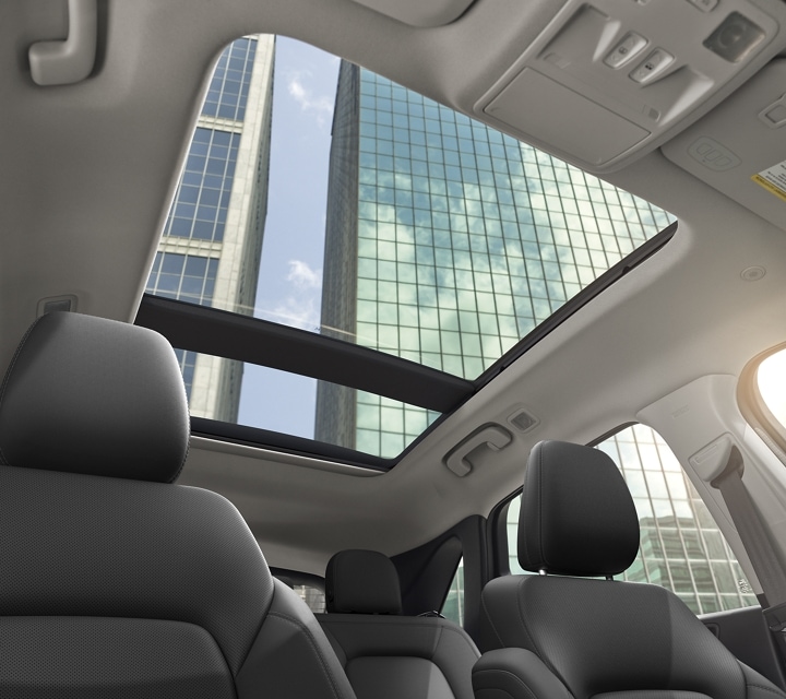 Panoramic Vista Roof® open, viewed from interior with glass skyscrapers visible