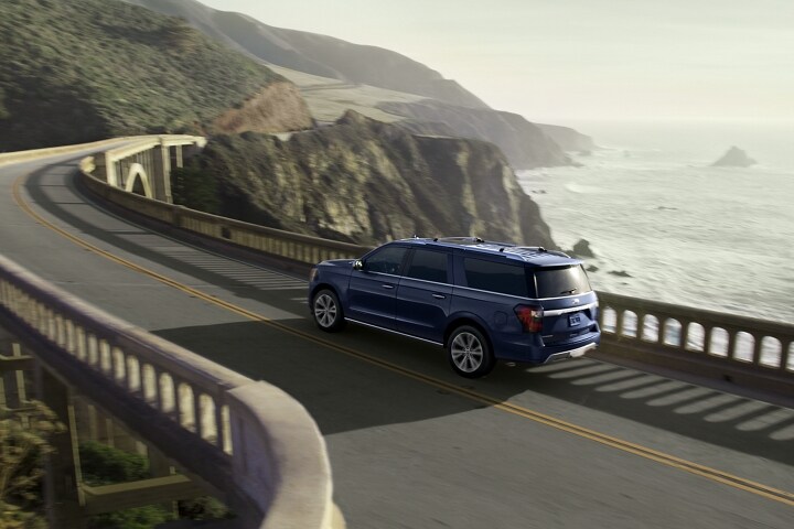Blue 2021 Ford Expedition Platinum MAX being driven by ocean
