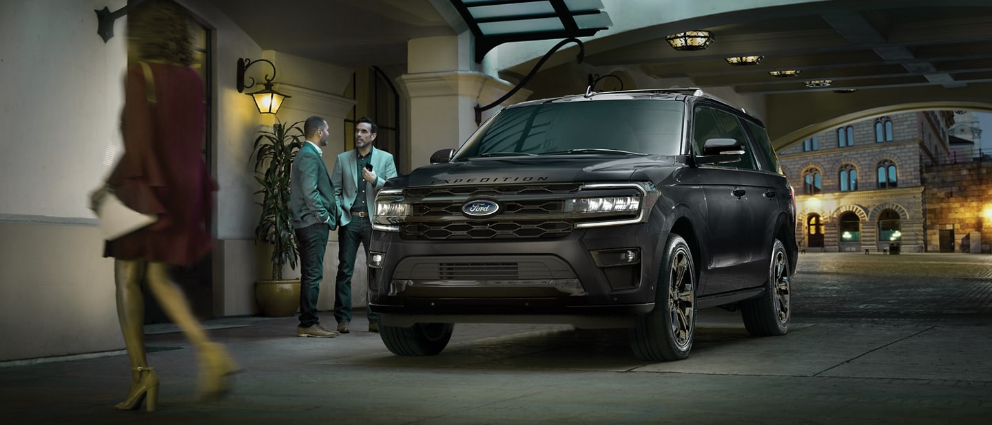 Two men standing next to a 2023 Ford Expedition SUV