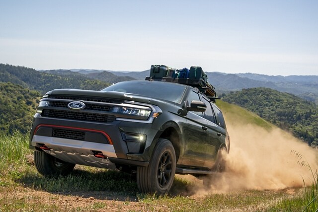 A 2023 Ford Expedition SUV being driven up a mountainous dirt path