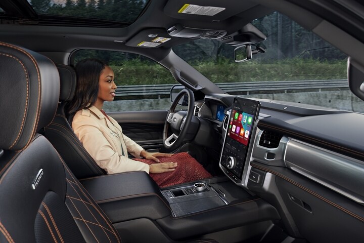 2023 Ford Expedition SUV being driven by woman utilizing BlueCruise feature.