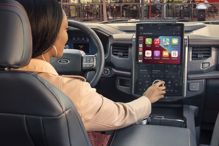A woman sitting in the driver’s seat of a 2023 Ford Expedition SUV