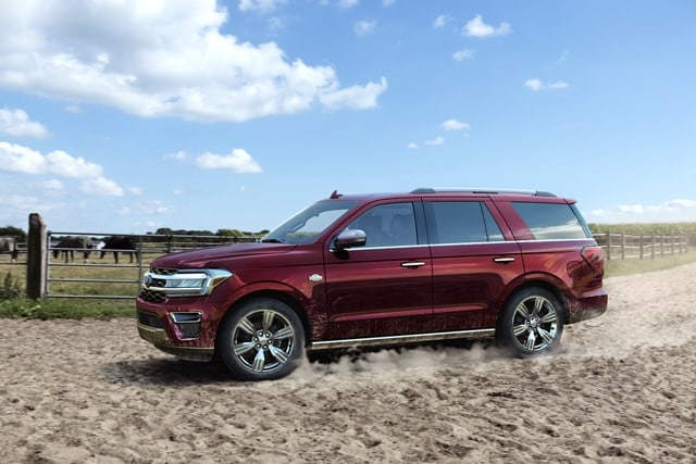 A 2023 Ford Expedition on a sandy dusty ranch off-road trail