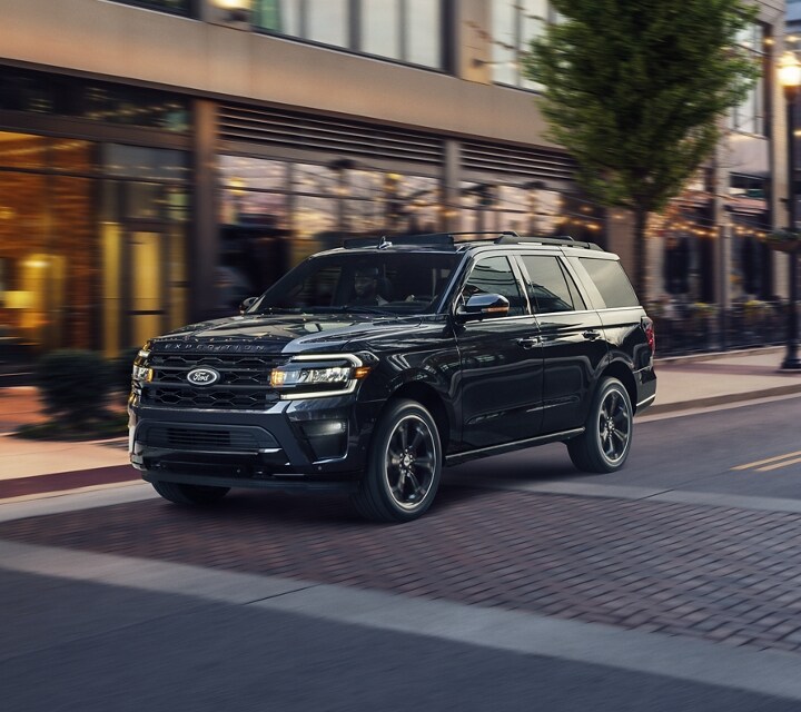 A 2024 Ford Expedition SUV being driven down a city street.