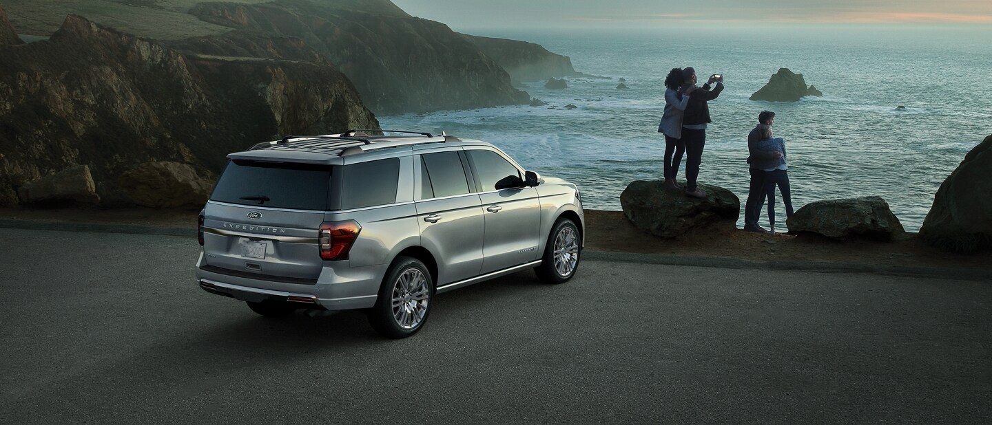 People taking photos of the ocean next to a 2024 Ford Expedition® SUV Platinum model