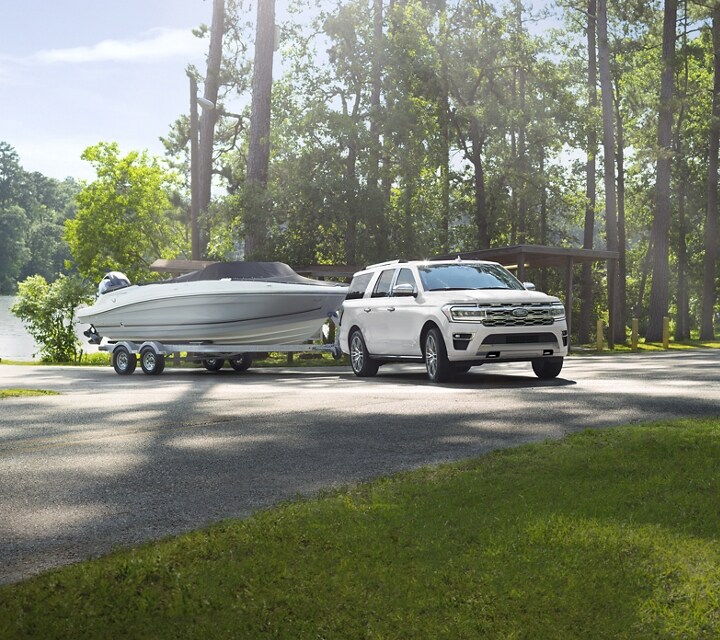 A 2024 Expedition SUV towing a boat at a boat launch