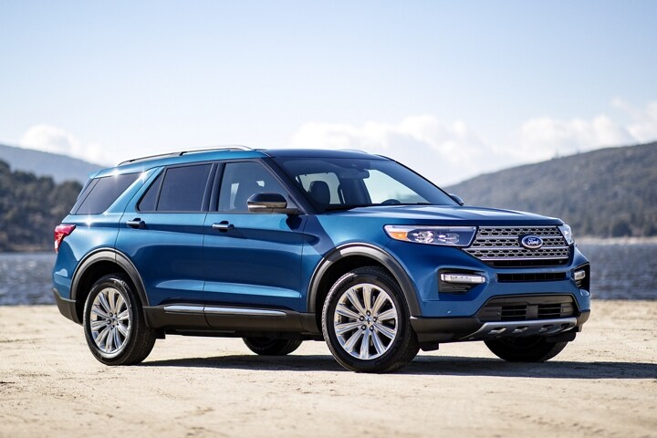 2023 Ford Explorer® Limited Hybrid model in Atlas Blue Metallic parked near a lake