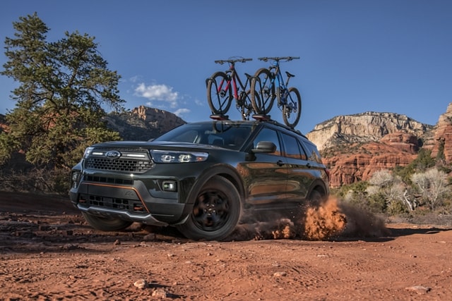 2023 Ford Explorer® Timberline® model being driven through the desert with bikes on the roof