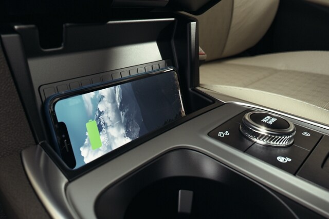 2023 Ford Explorer® SUV interior closeup of a smart phone lying sideways on the wireless charging pad