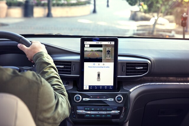 2023 Ford Explorer® SUV interior showing touchscreen and a person driving