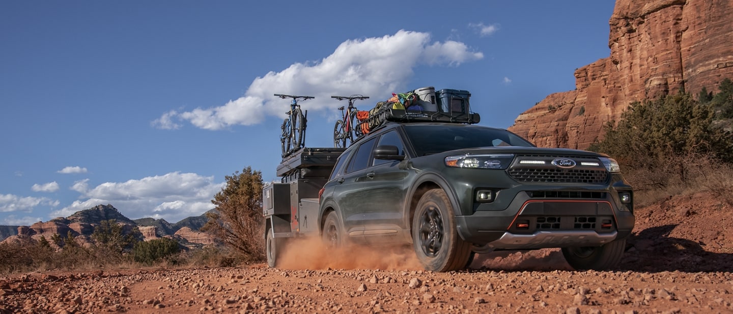 2023 Ford Explorer® Timberline® SUV towing a camper in the desert