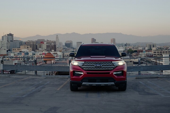 2023 Ford Explorer® Limited Hybrid model in Rapid Red Metallic Tinted Clearcoat (extra cost colour option) in a parking lot