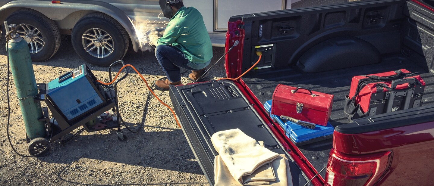A person using pro power on board to weld a trailer
