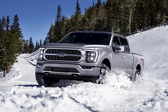 A 2021 Ford F 1 50 being driven through snow