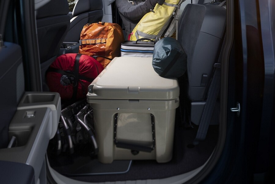 View of the rear cab cargo space loaded with camping gear