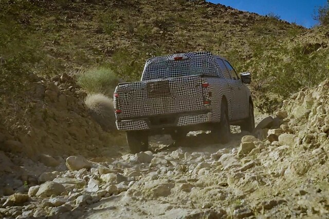 2023 Ford F-150® covered in disguise wrap off-roading through a desert gully