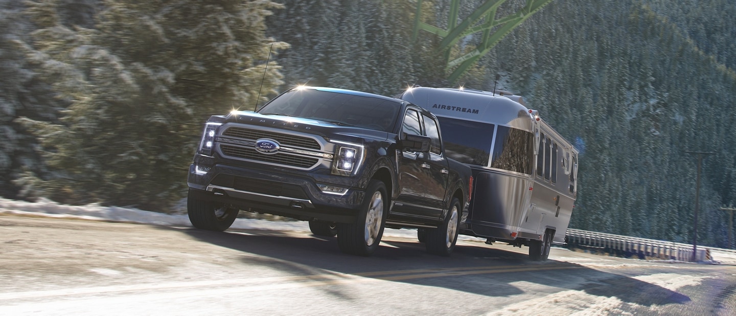 2023 Ford F-150® pulling an airstream camper on a mountain roadway