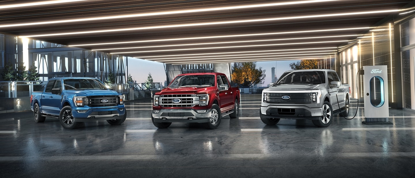 2023 Ford F-150® in Atlas Blue, F-150® PowerBoost™ hybrid in Rapid Red and a F-150® Lightning® in Iced Blue Silver