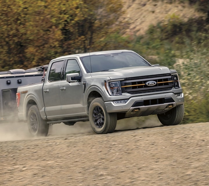 2023 Ford F-150® Tremor® with Tow package driving down a dirt road