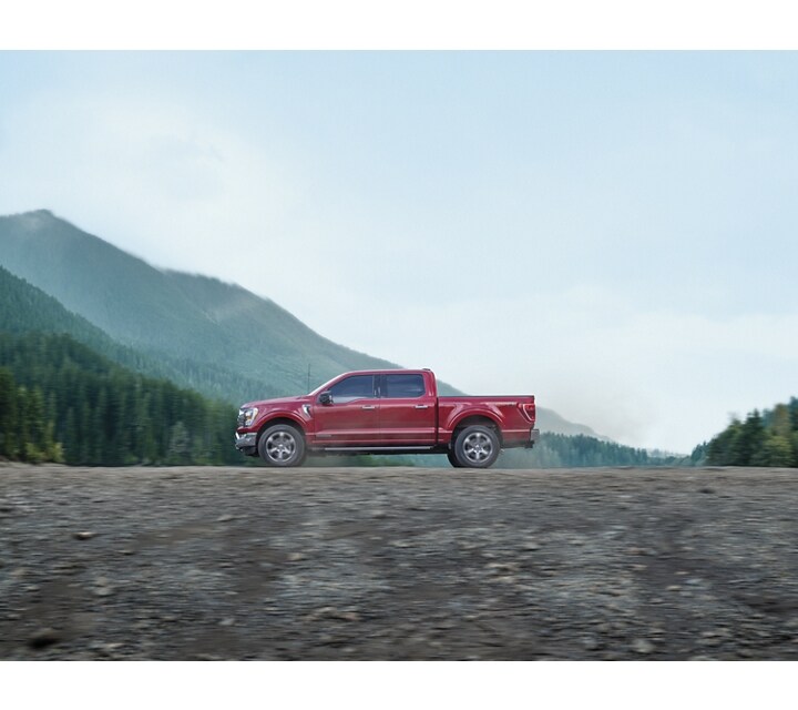 2023 Ford F-150® XLT Crew Cab in Rapid Red being driven on a mountain road