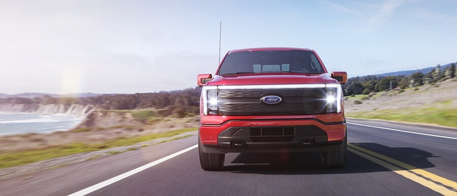 2023 Ford F-150® Lightning® being driven on an oceanside road