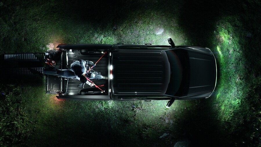 Overhead shot of the zone lighting illuminating the ground around a 2023 Ford F-150® Lightning®
