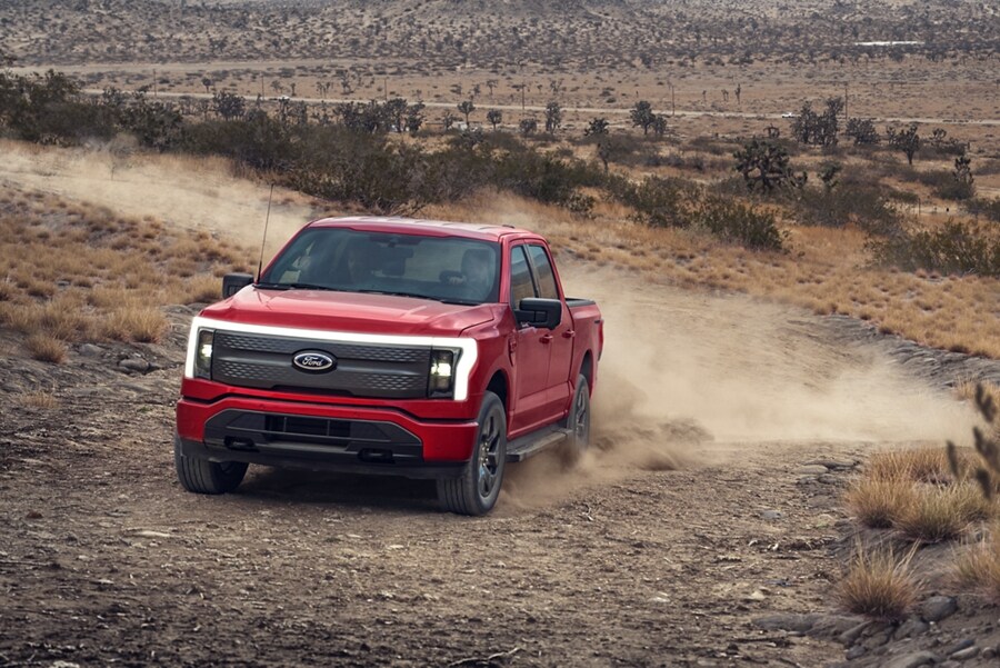 A 2023 Ford F-150® Lightning® being driven through desert