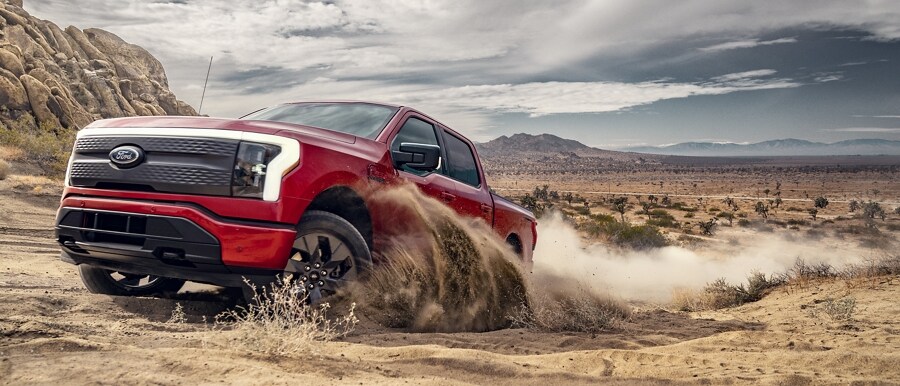 2023 Ford F-150® Lightning® being driven in the sand