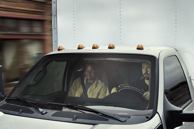 Driver and passenger seen through 2023 Ford F-750 windshield