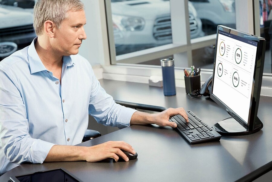 A person sitting and using a desktop computer