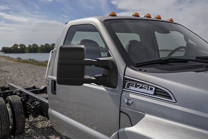 Close-up of mirrors on a 2024 Ford F-750 Regular Cab in Ingot Silver parked near water