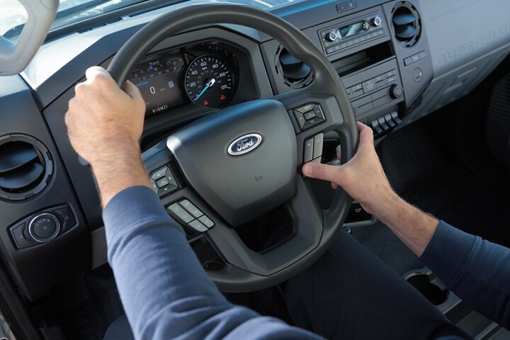 Hands-using wheel-mounted controls on 2024 Ford F-750 steering column
